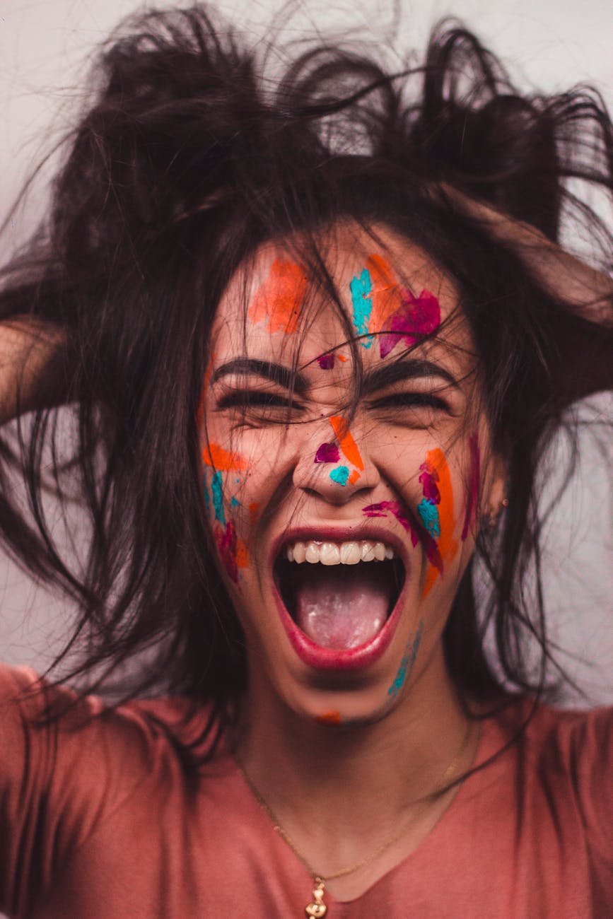 a woman with face paint screaming